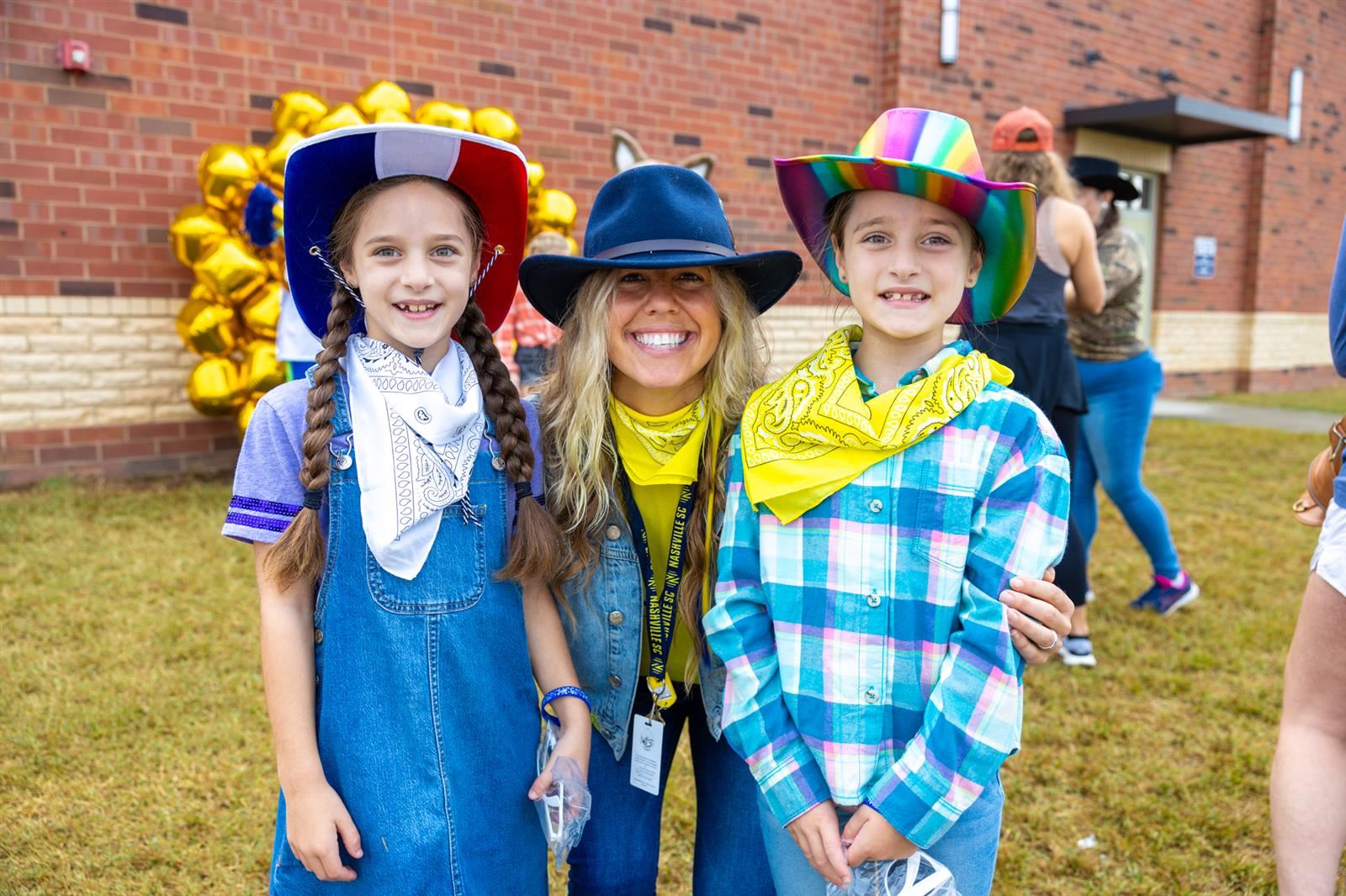 teacher and two students smiling